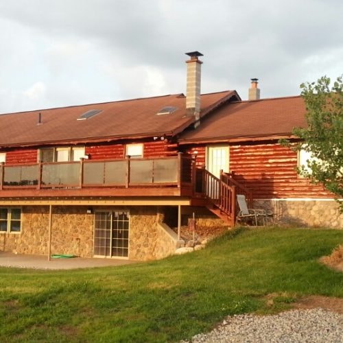 Log cabin with deck finished in Timbertone