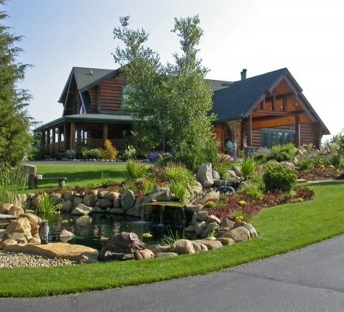 Log cabin with pond finished in Sierra Cedar